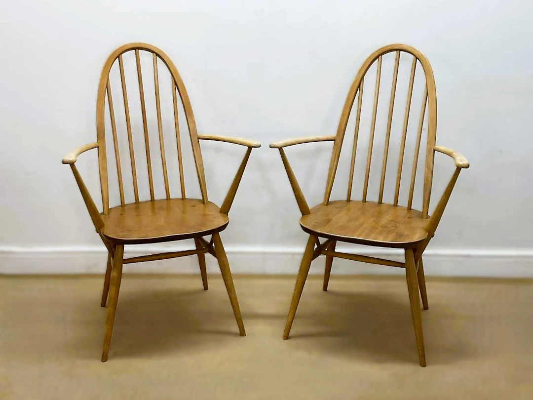 ERCOL; a pair of beech and elm 'Quaker' carver chairs