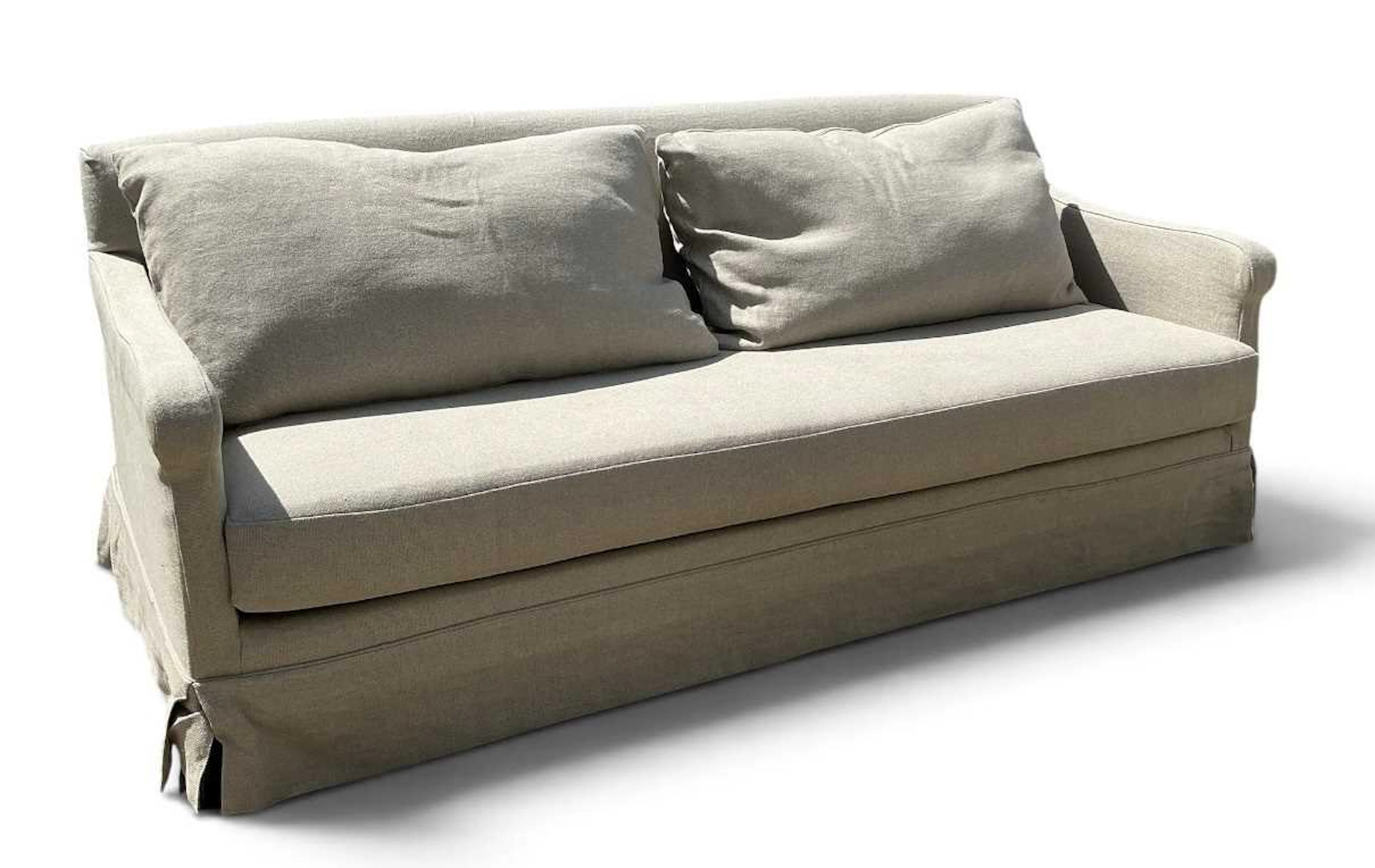A large modern contemporary cream upholstered three seater sofa
