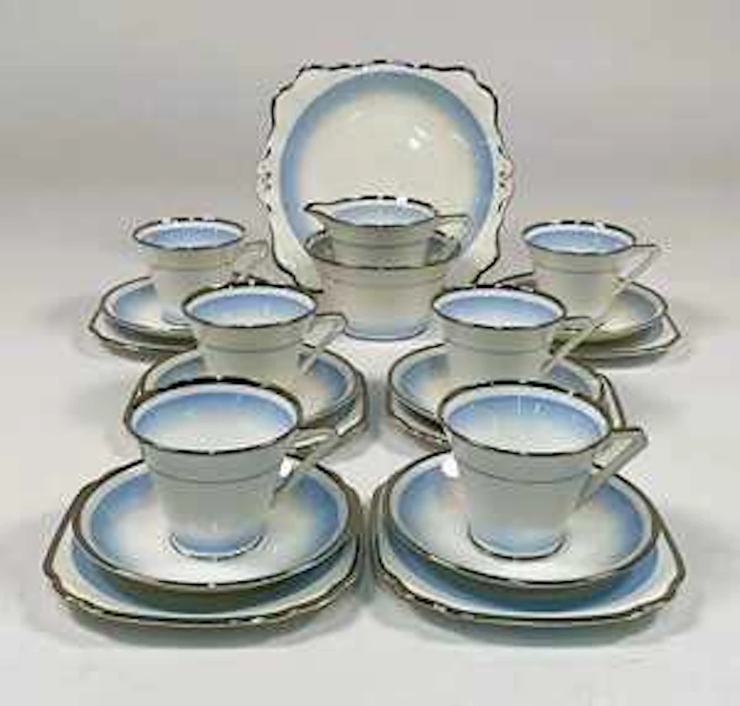 An Art Deco bone china part teaset in pale blue with silver border detail