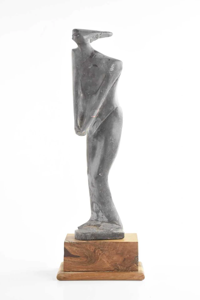 JOHN OWEN; a carved slate model of a stylised figure