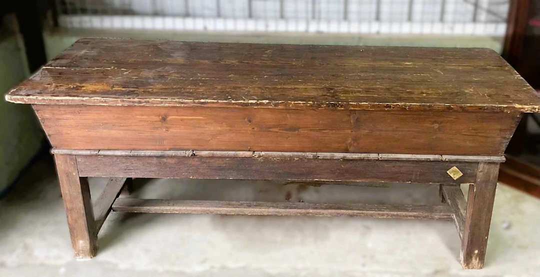 A 19th century pine grain store with a plank top and a fitted interior