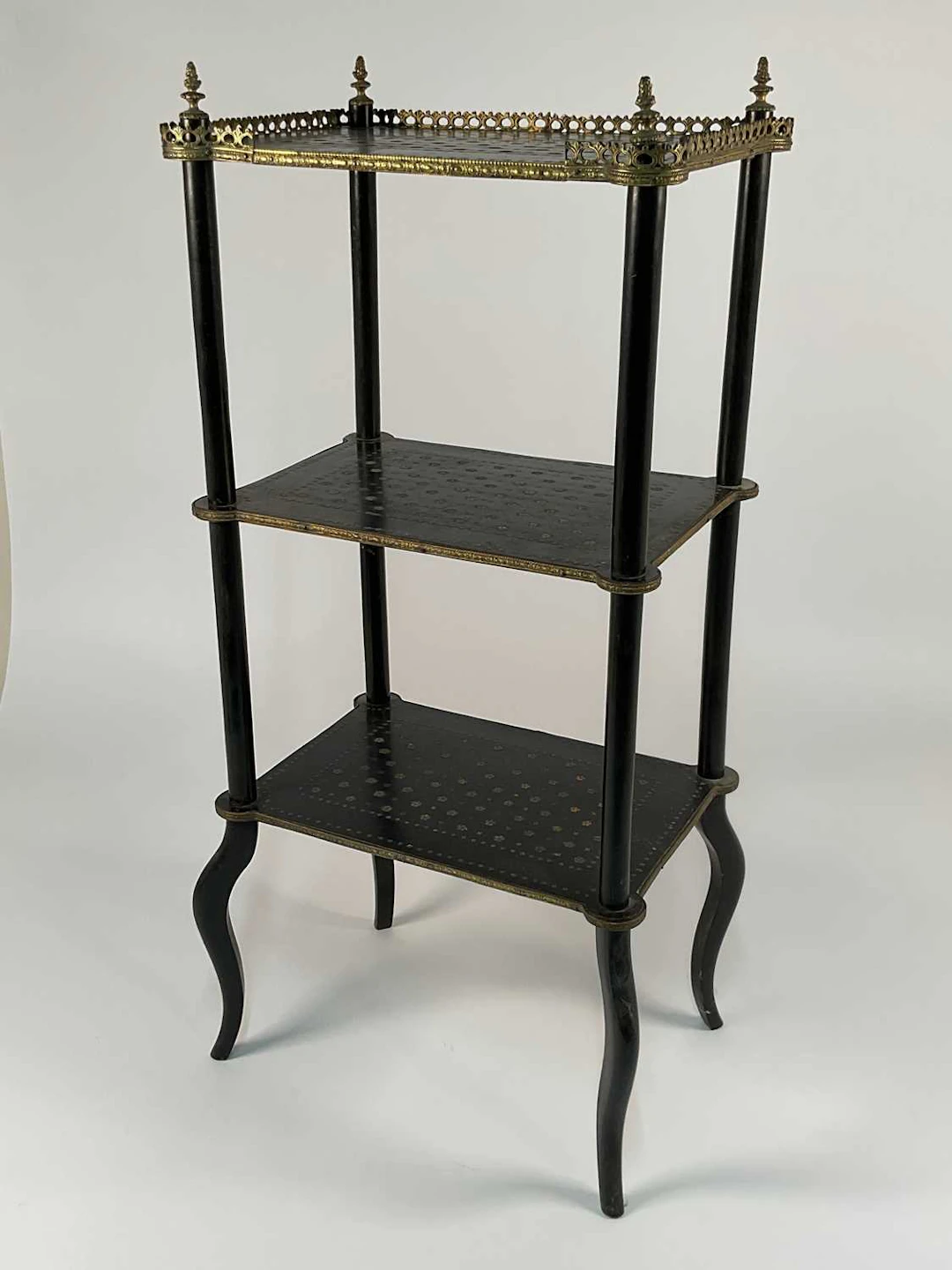 A 19th century ebonised three tier what not with brass...