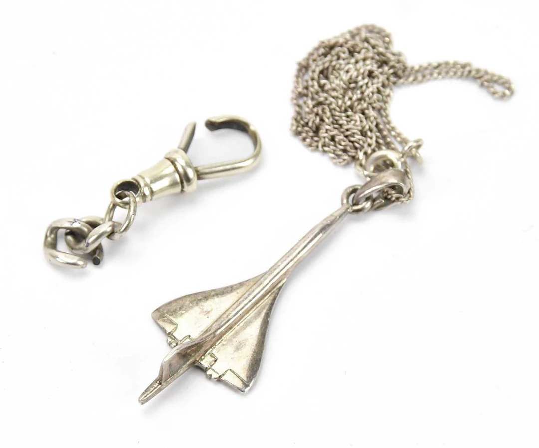A sterling silver pendant formed as Concorde on a finelink chain