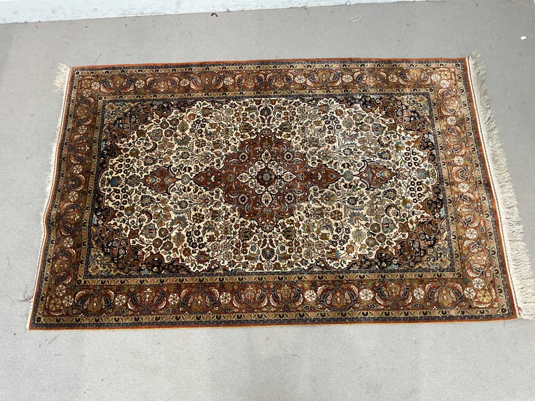 A good quality oarange ground silk on silk Kashmir carpet