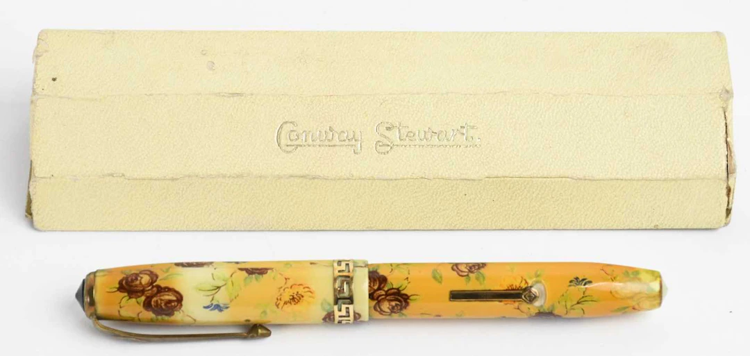 CONWAY STEWART; a 1950s yellow metal mounted floral No