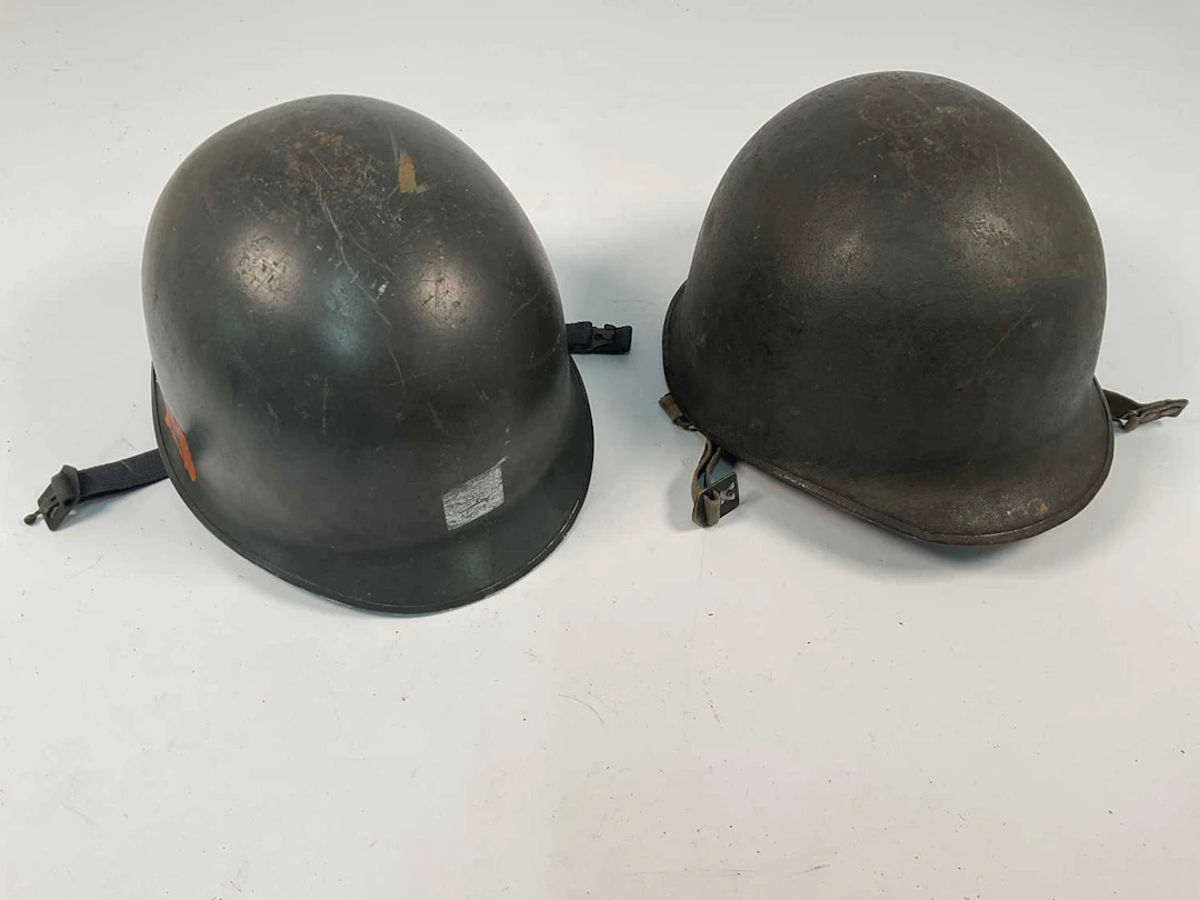 Two WWII era American helmets