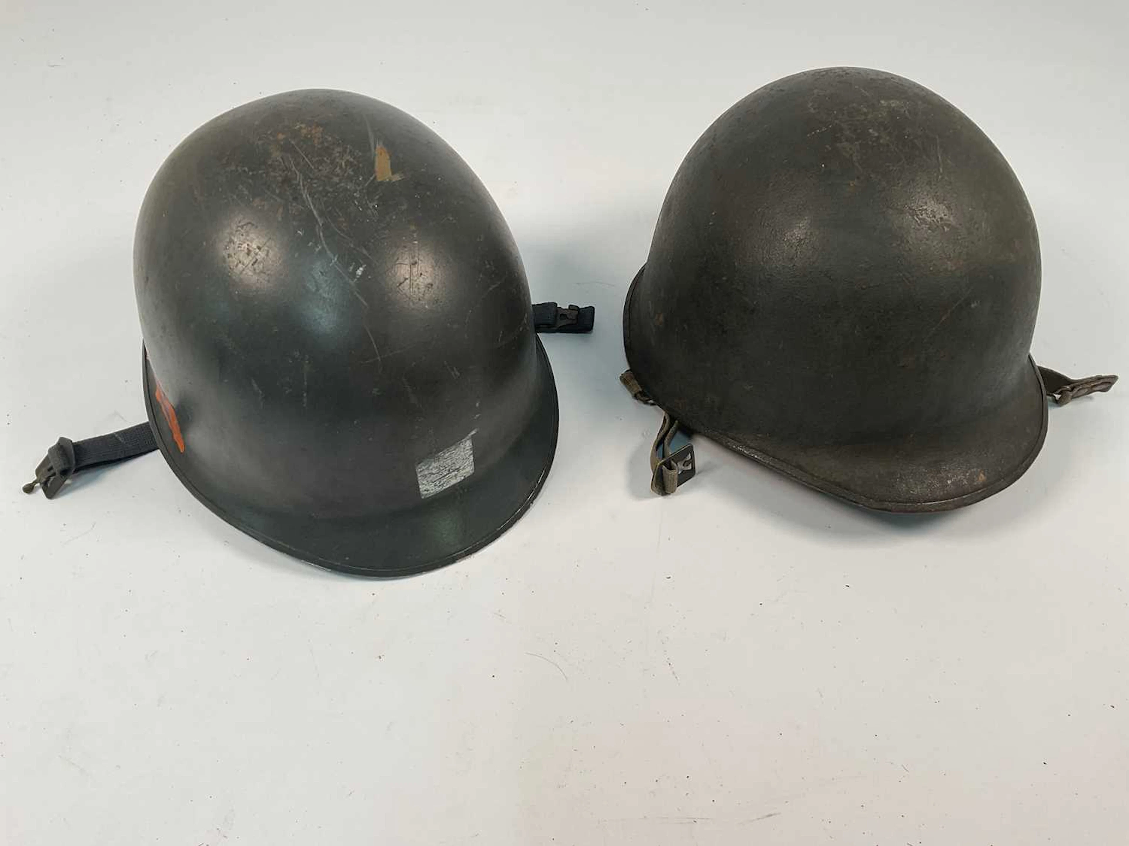 Two WWII era American helmets