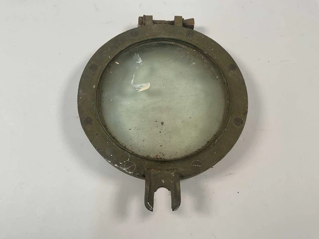 A small brass ship's portal outer