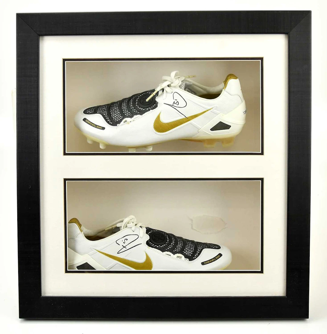 RIO FERDINAND; a framed pair of autographed Nike Total 90 football boots