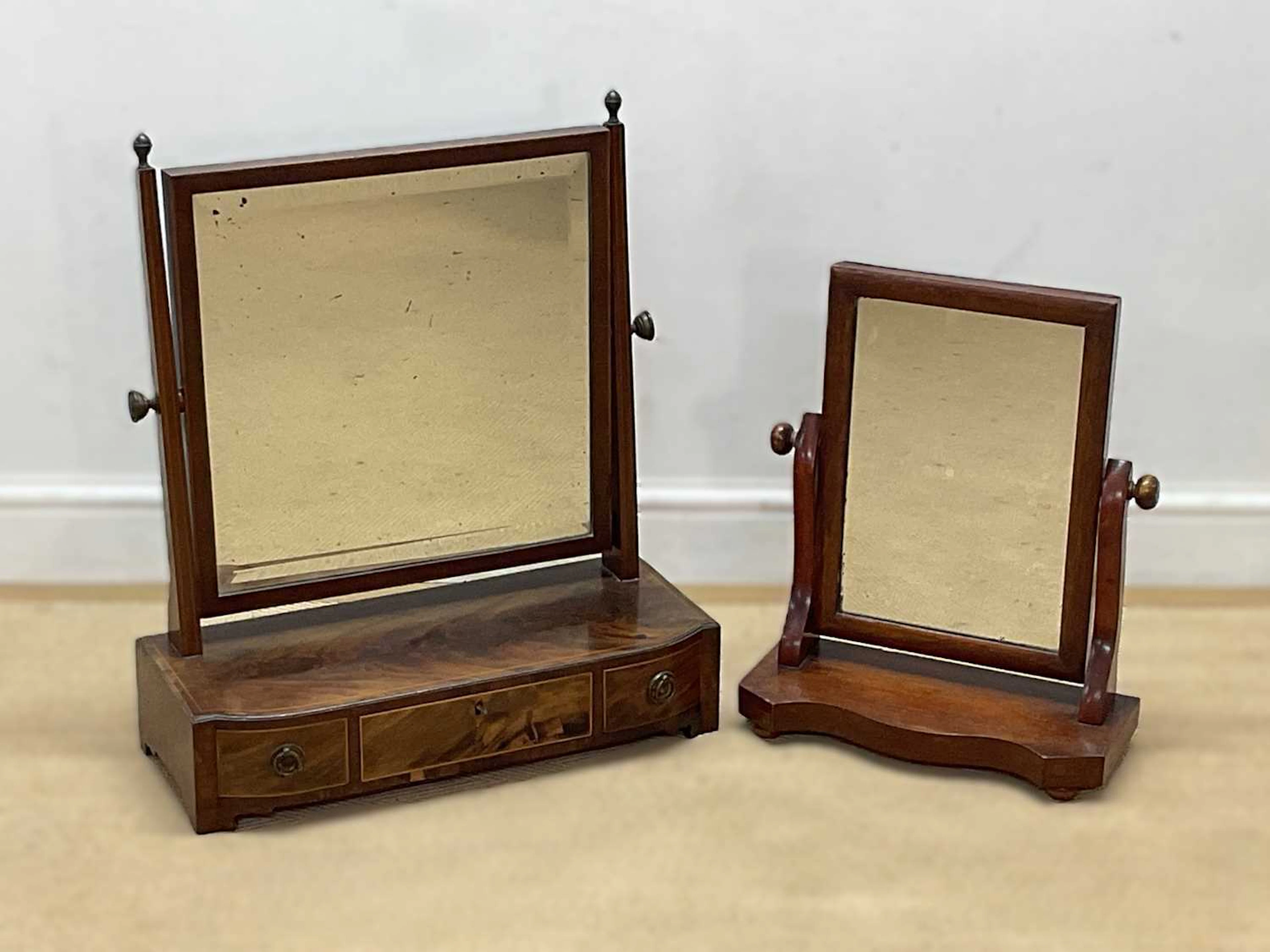 A walnut veneered dressing table mirror with three drawers
