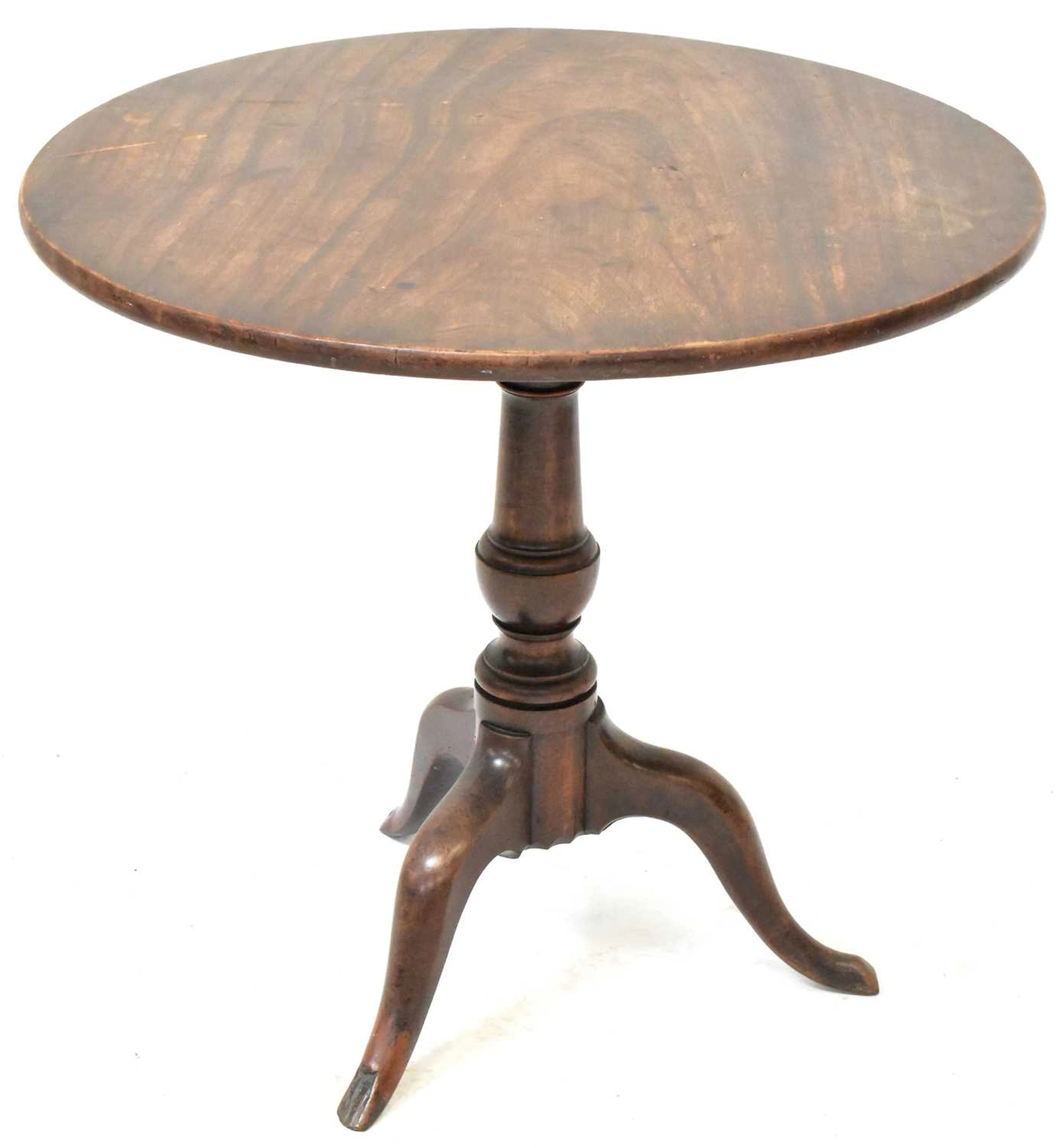 A George III circular mahogany tilt-top table on a gun...