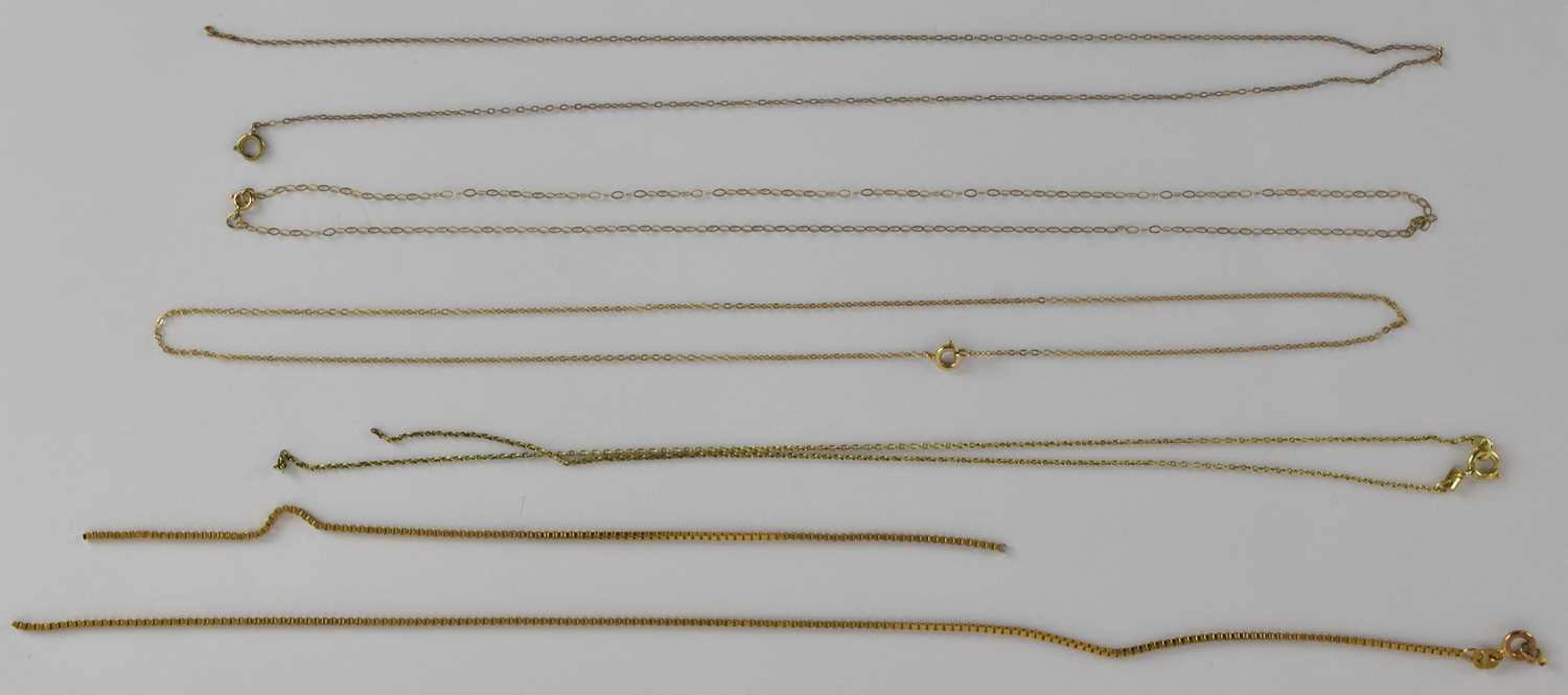 A quantity of scrap 9ct and yellow metal cut and broken necklaces