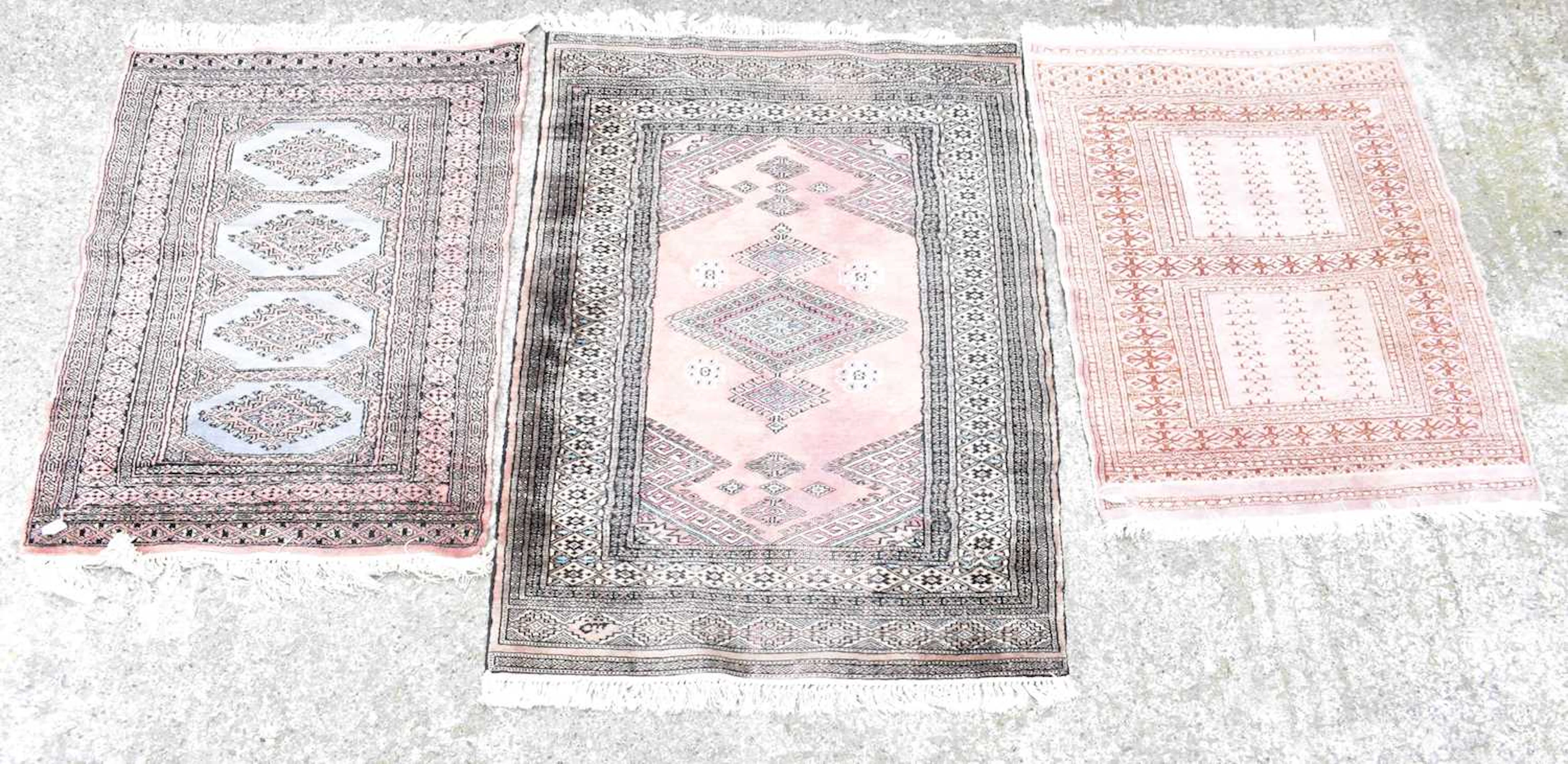 Three rugs of pink ground