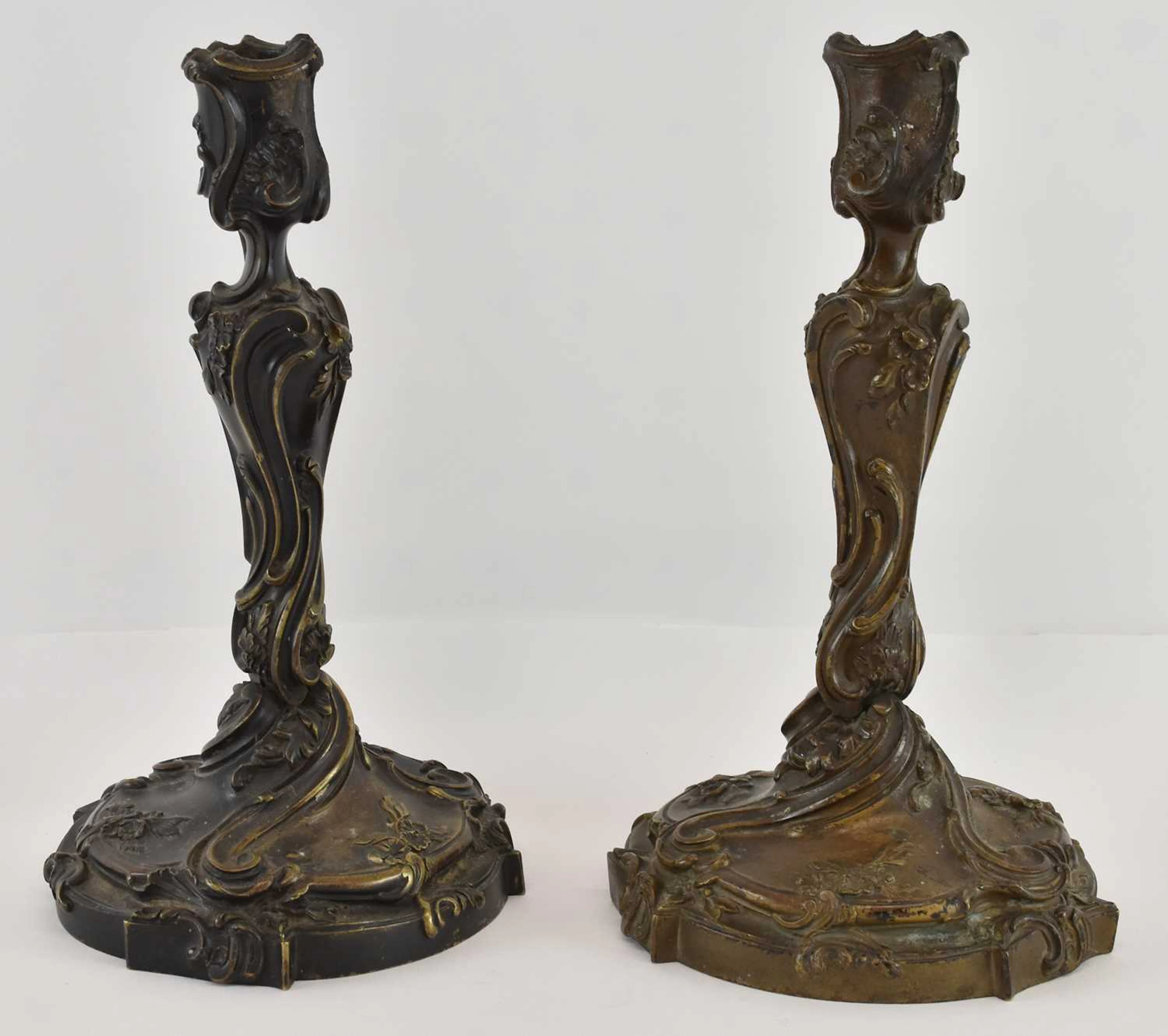 A pair of French Louis XV style cast bronze candlesticks