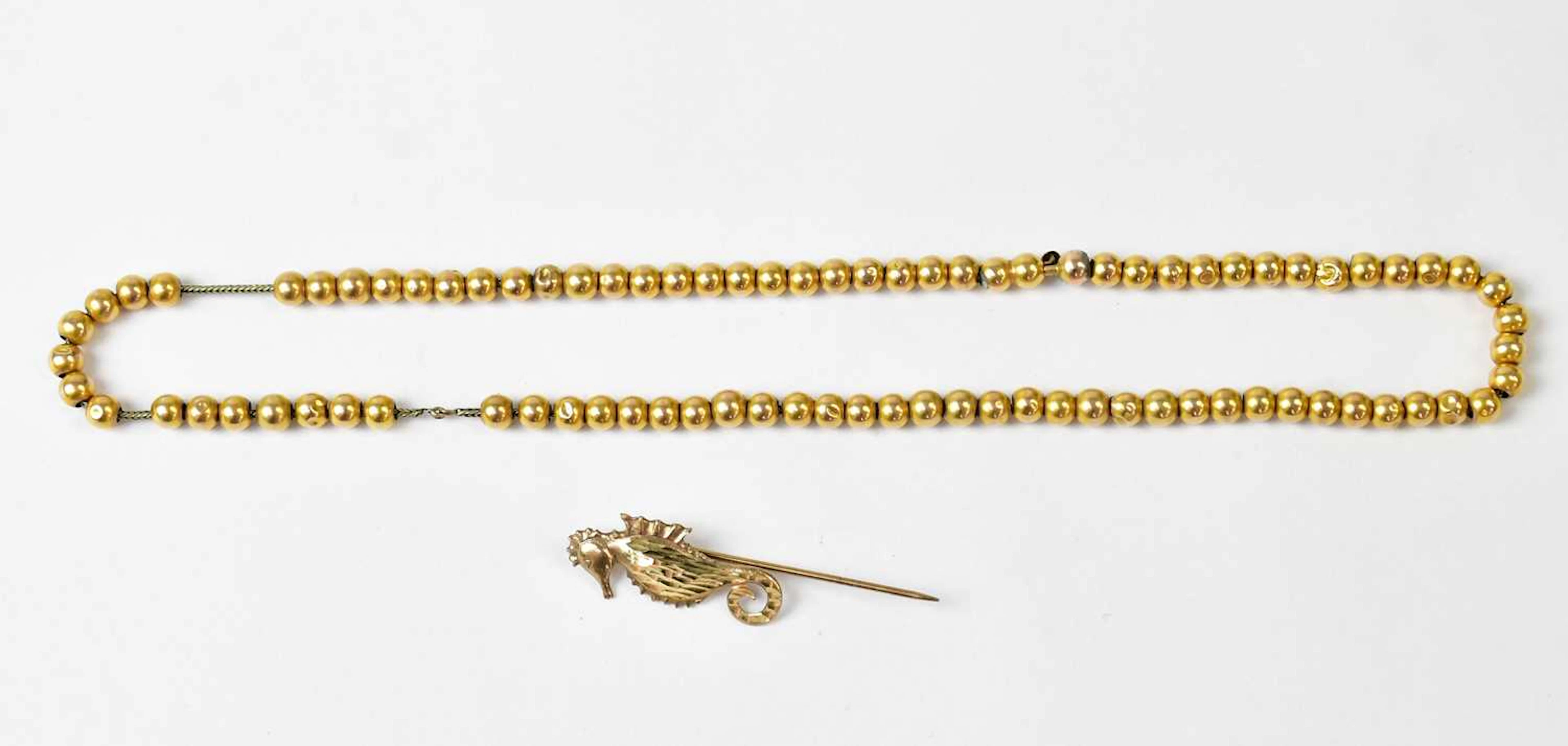 A 1970s 9ct yellow gold pin in the form of a seahorse