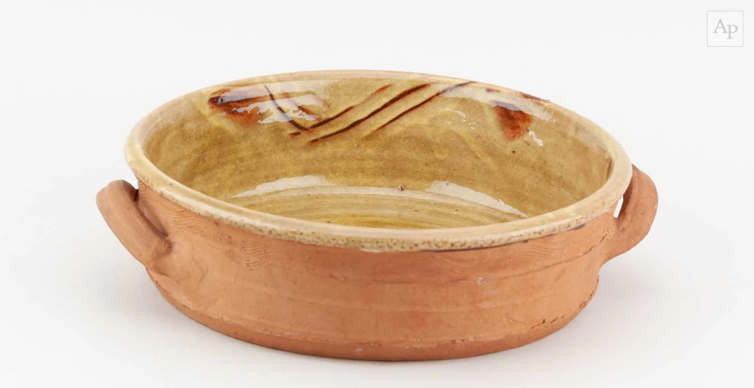 CLIVE BOWEN (born 1943); a slipware twin handled baking...