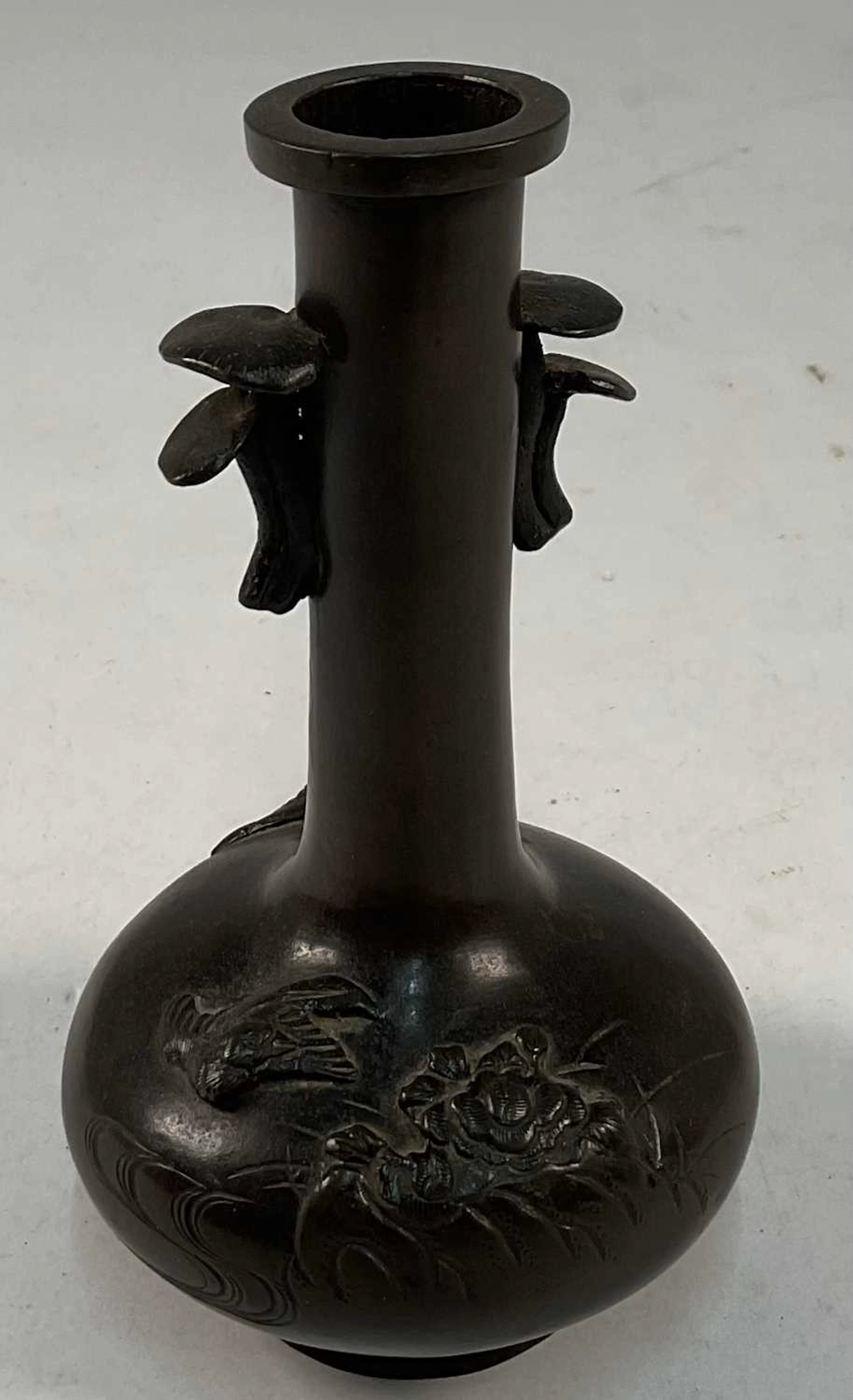 A 19th century Chinese bronze vase with raised floral...