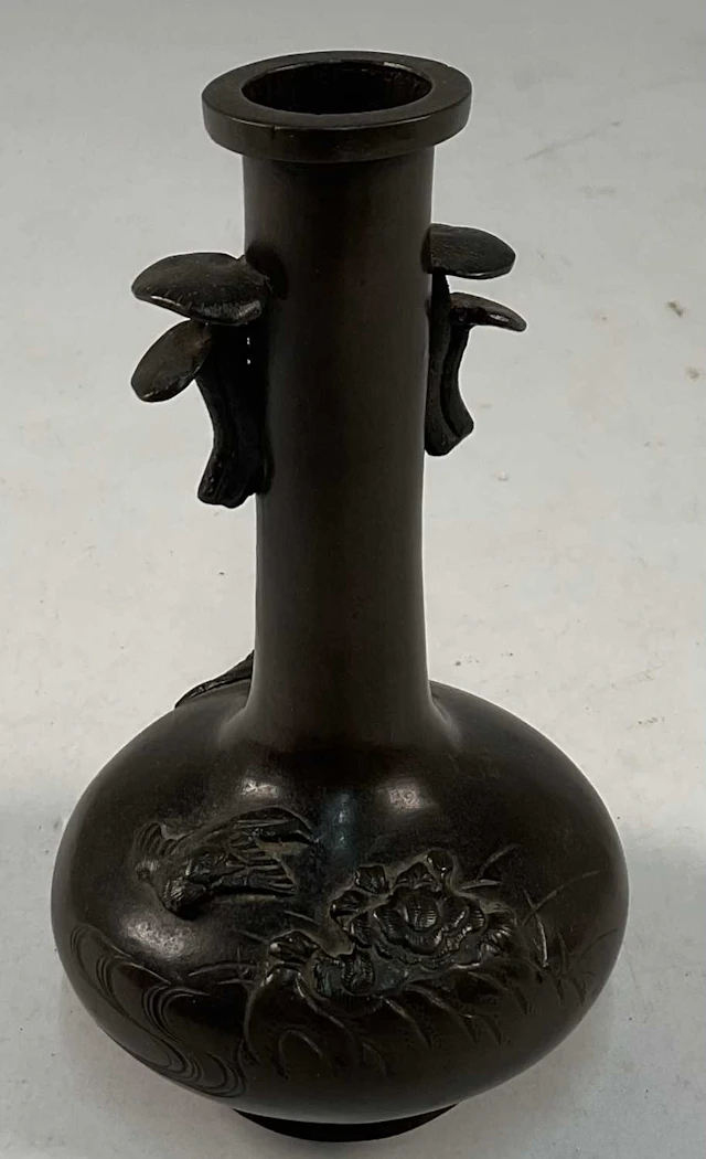 A 19th century Chinese bronze vase with raised floral...