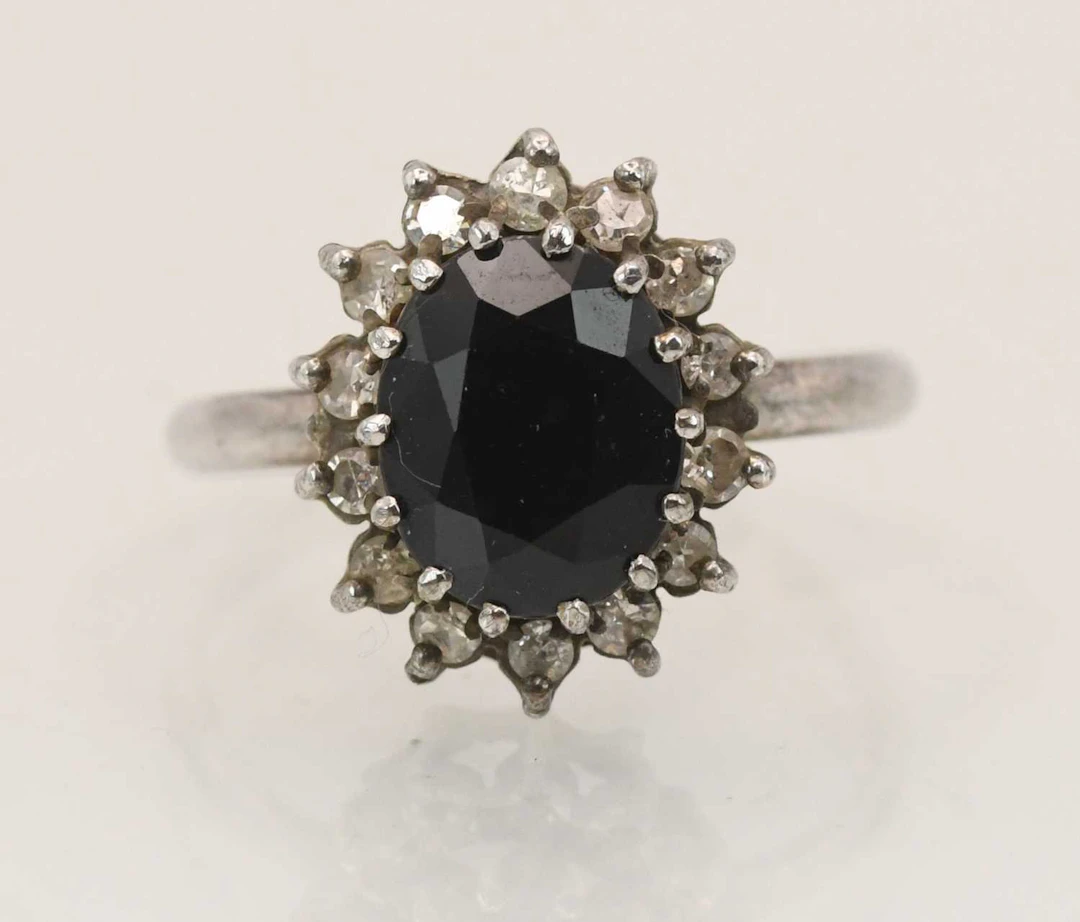 A 9ct white gold sapphire and diamond cluster ring