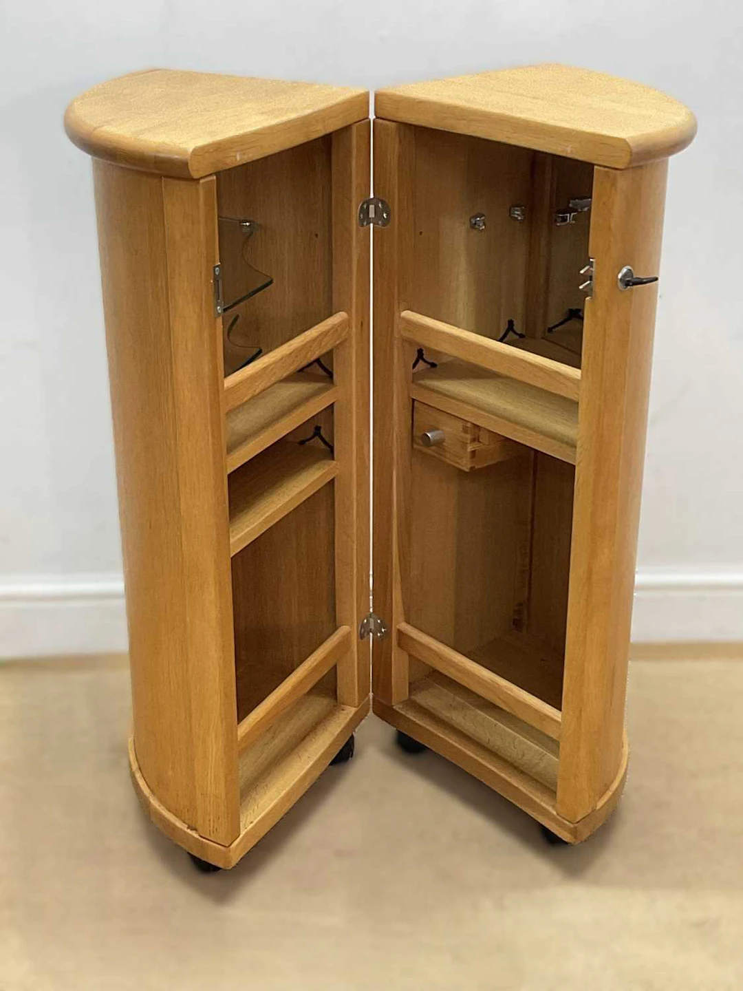 A modern wooden clamshell drinks cabinet