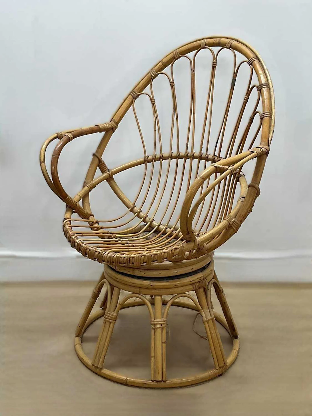 A mid 20th century bamboo swivel egg chair