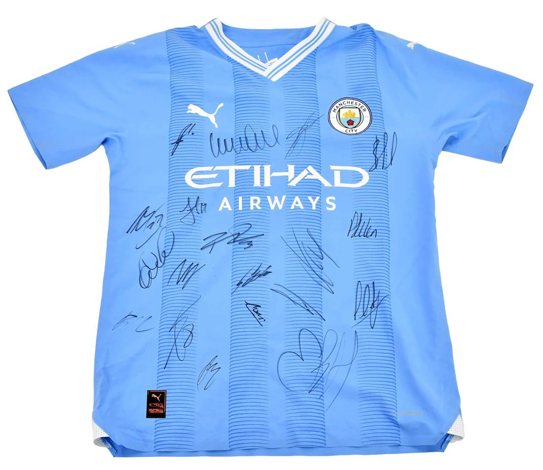 MANCHESTER CITY INTEREST; an autographed player issue jersey signed by the team