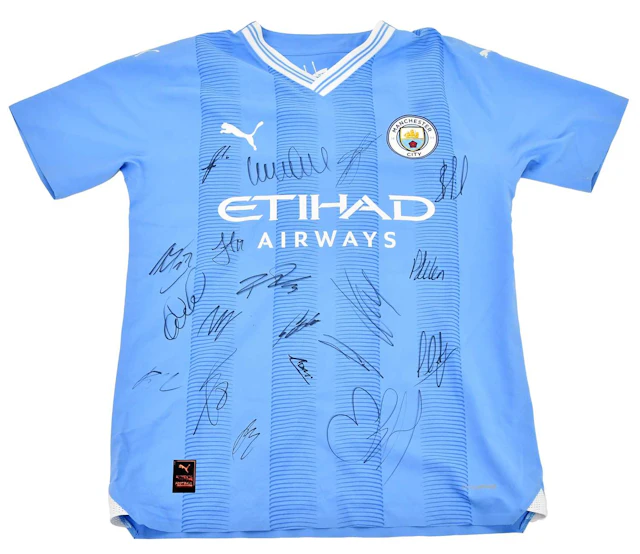 MANCHESTER CITY INTEREST; an autographed player issue jersey signed by the team