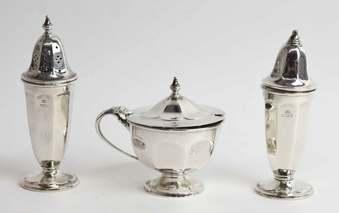 A George VI hallmarked silver three piece cruet