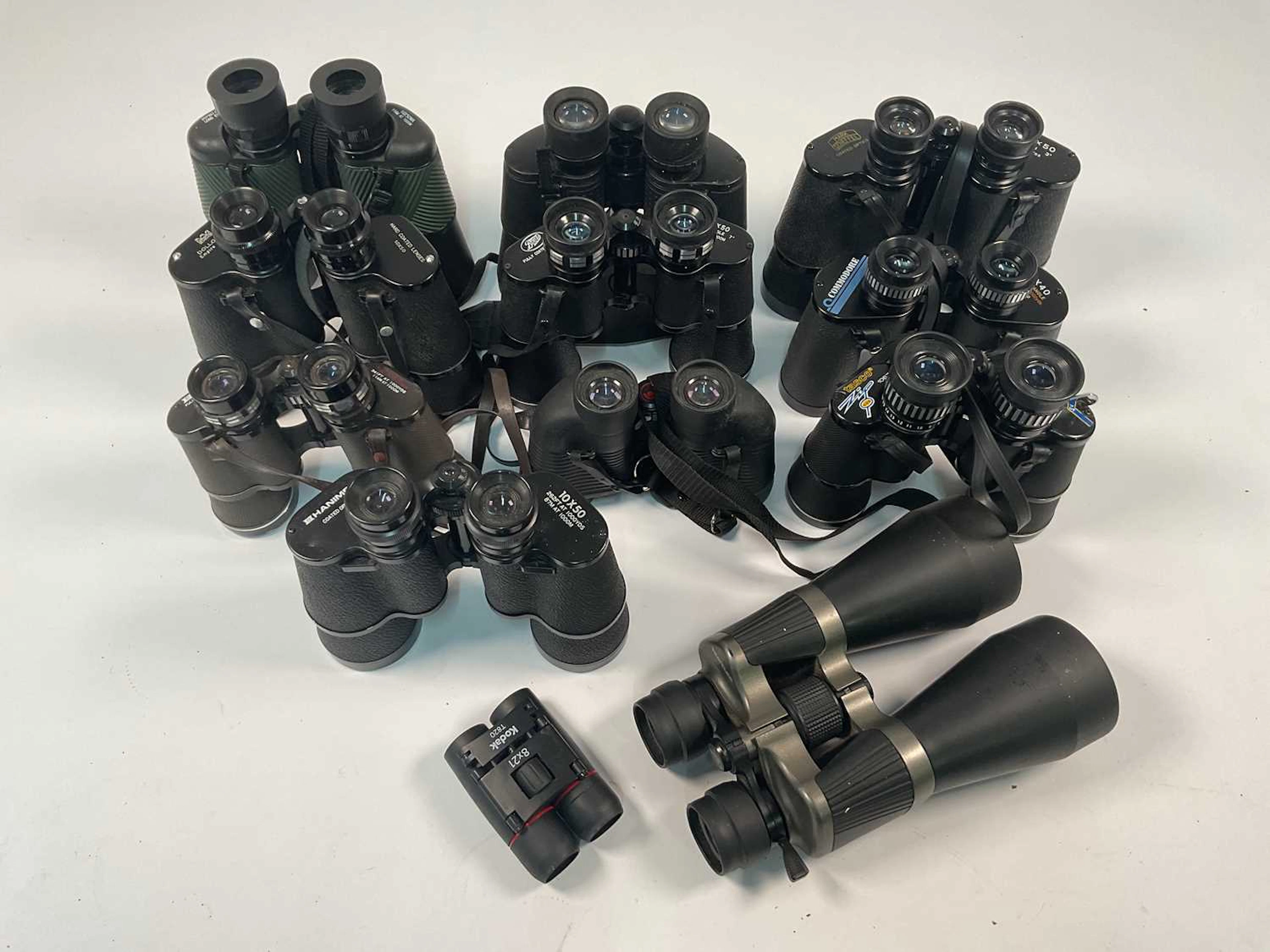 A quantity of binoculars with cases