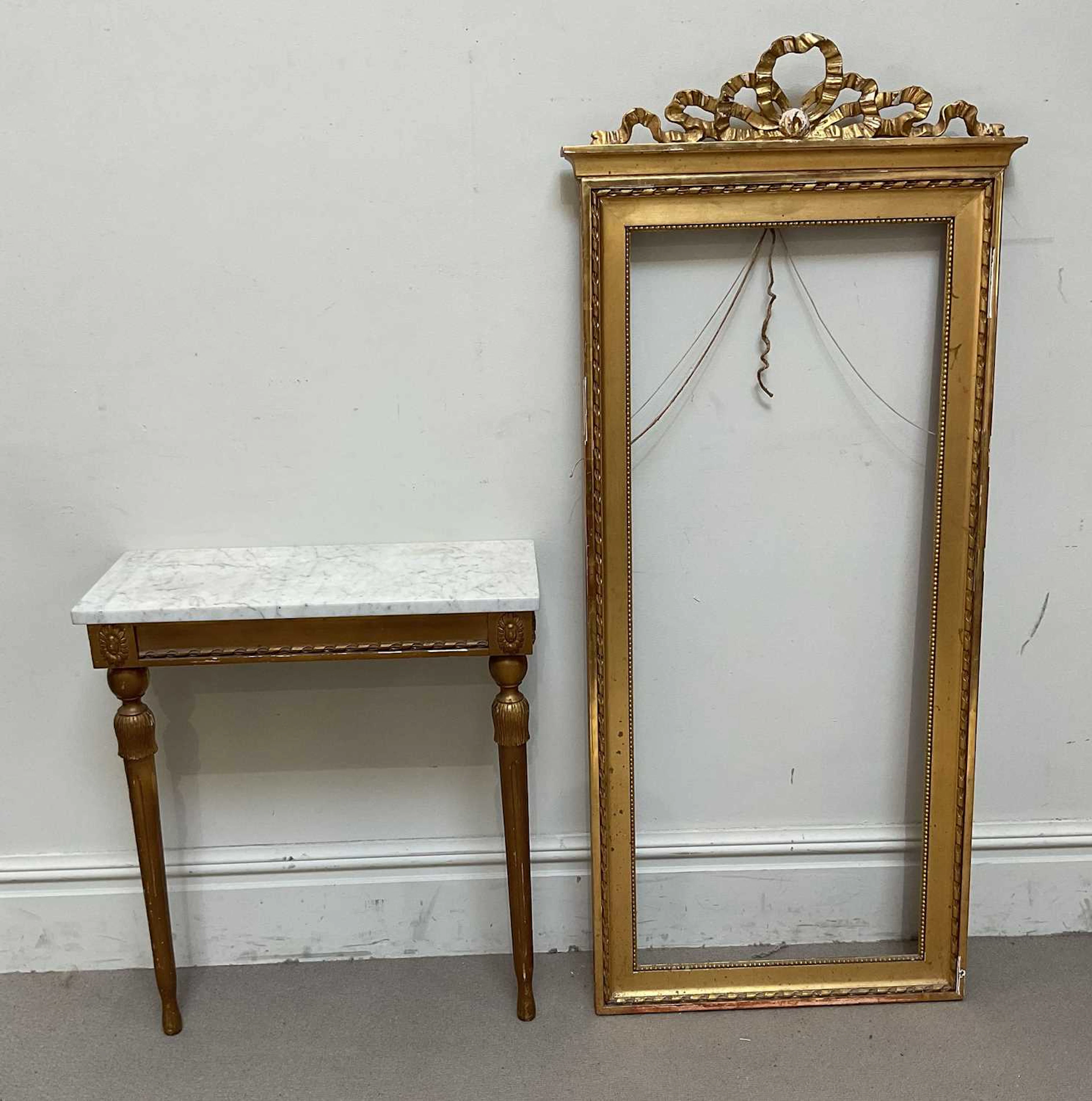 A 19th century style gilt pier glass frame with ribbon swag pediment
