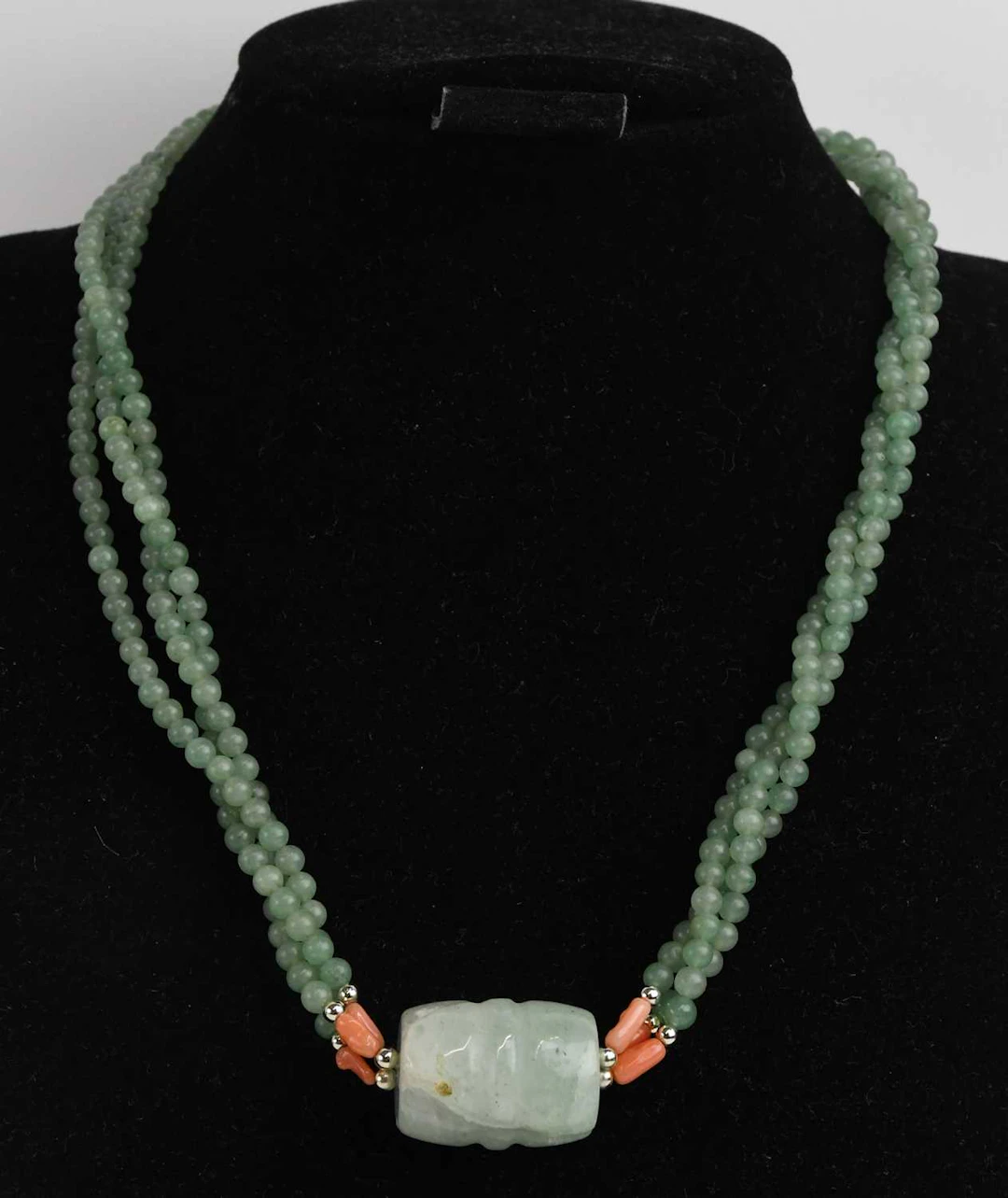 A twisted three strand apple green jade necklace