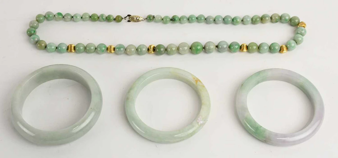 A Chinese single strand apple green jade bead necklace