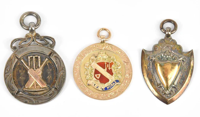 A yellow metal and enamel sporting medal