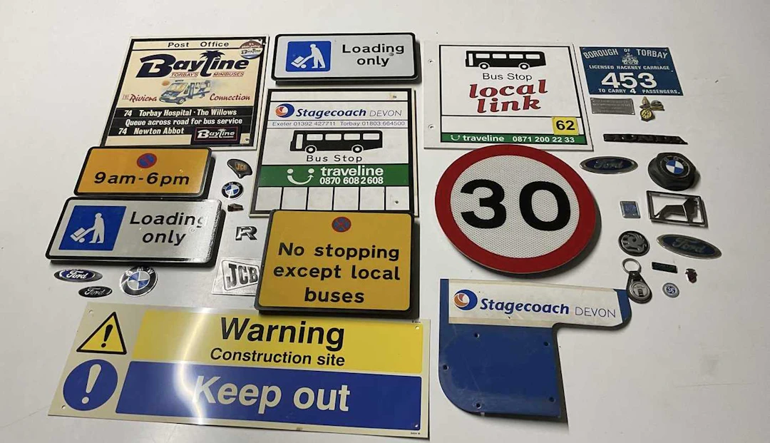 A collection of road signs and car badges