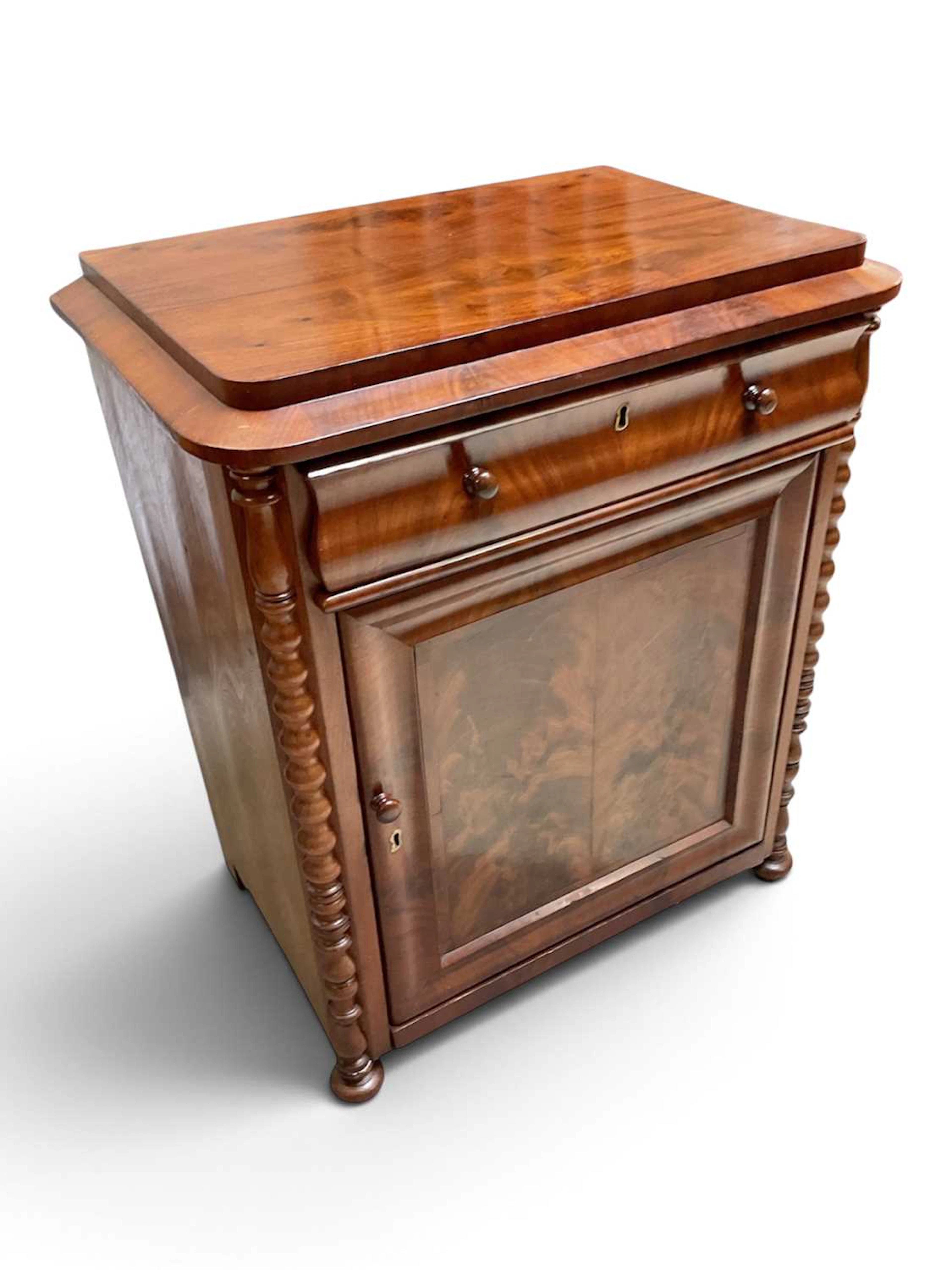 A 19th century Continental flame mahogany side cabinet with drawer above door