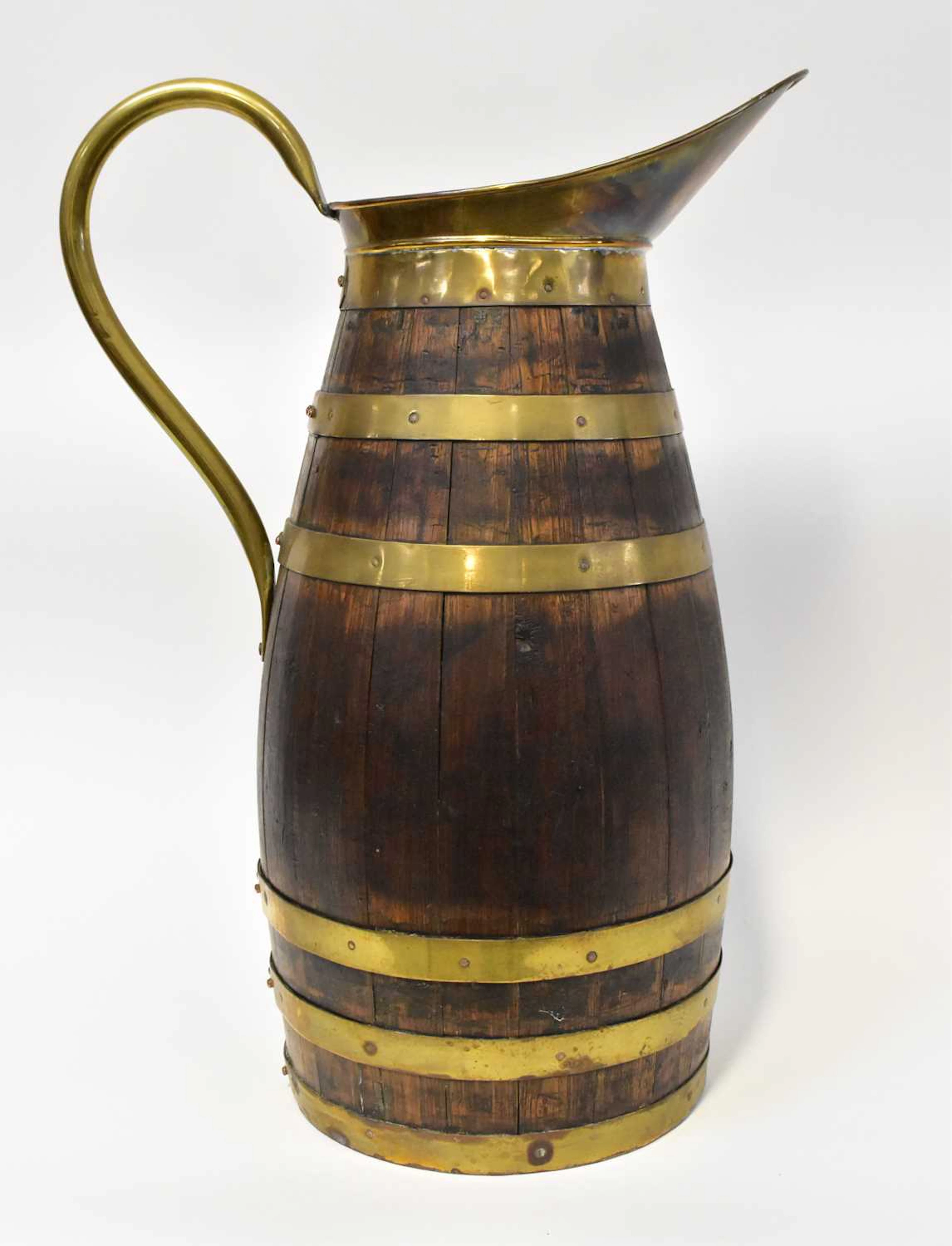 A 19th century brass-bound coopered jug of ovoid form