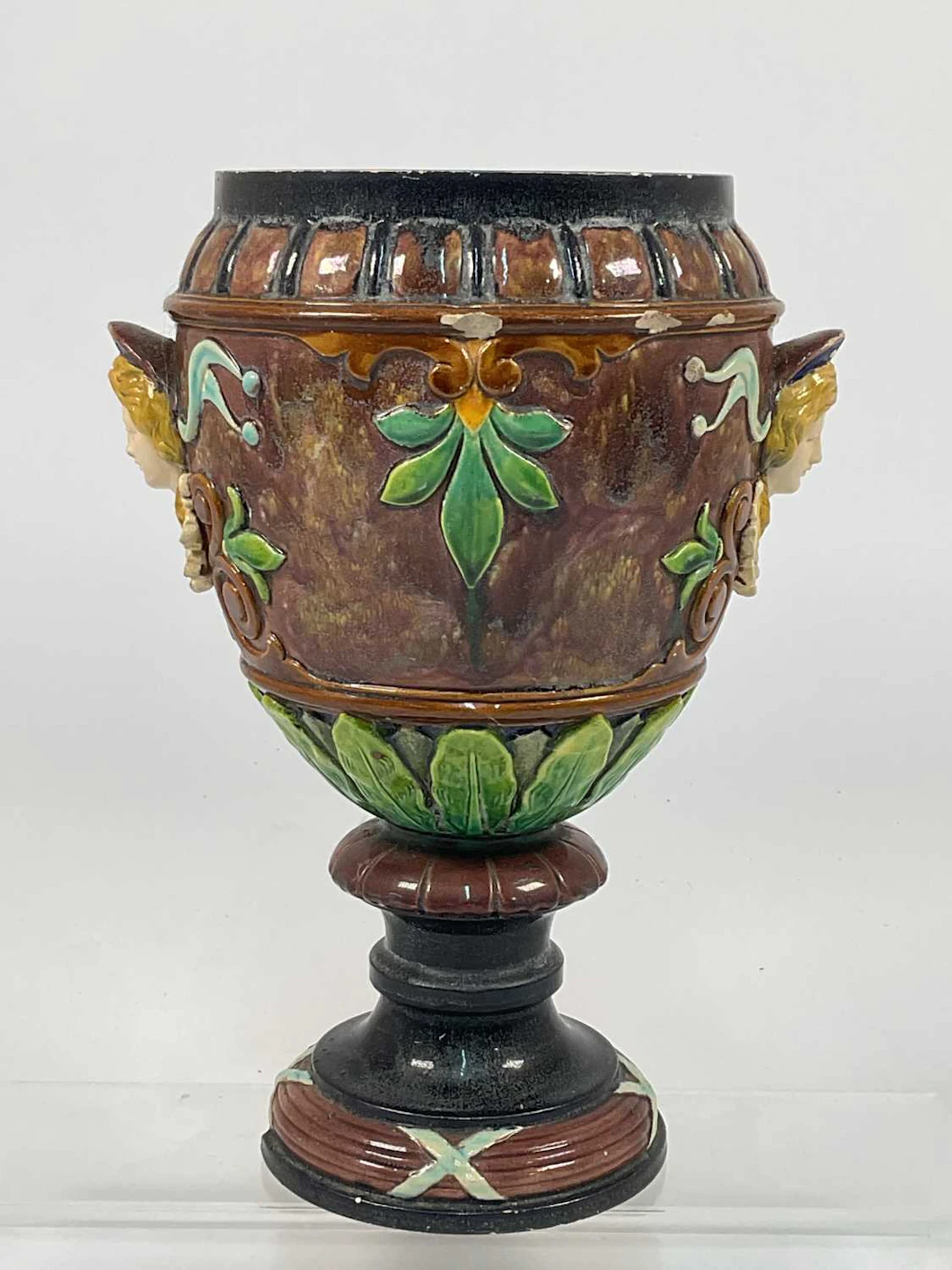 A 19th century majolica vase decorated with raised relief...