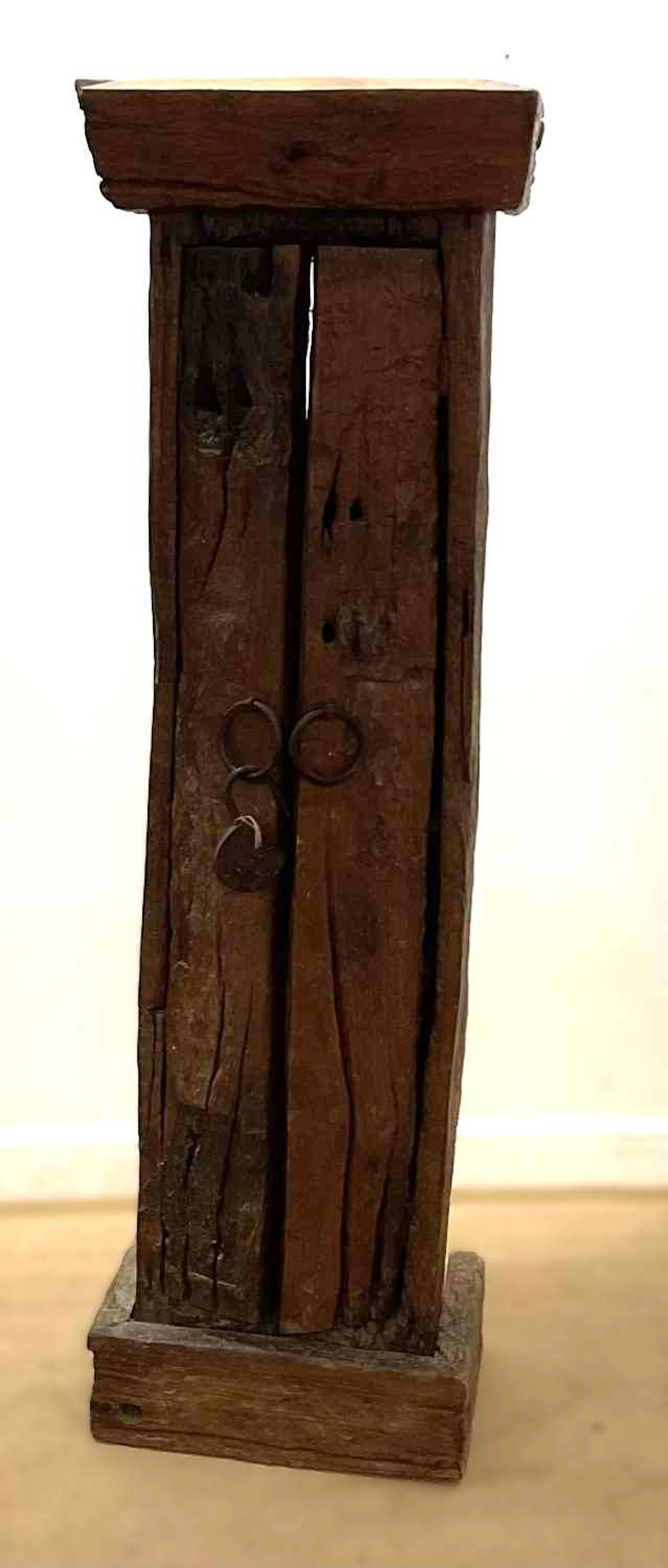 An Indonesian hardwood twin door cabinet having five fitted shelves