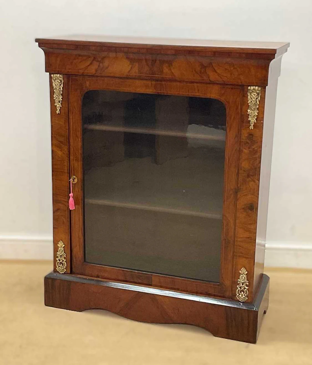 A Victorian walnut pier cabinet with two velvet lined shelves