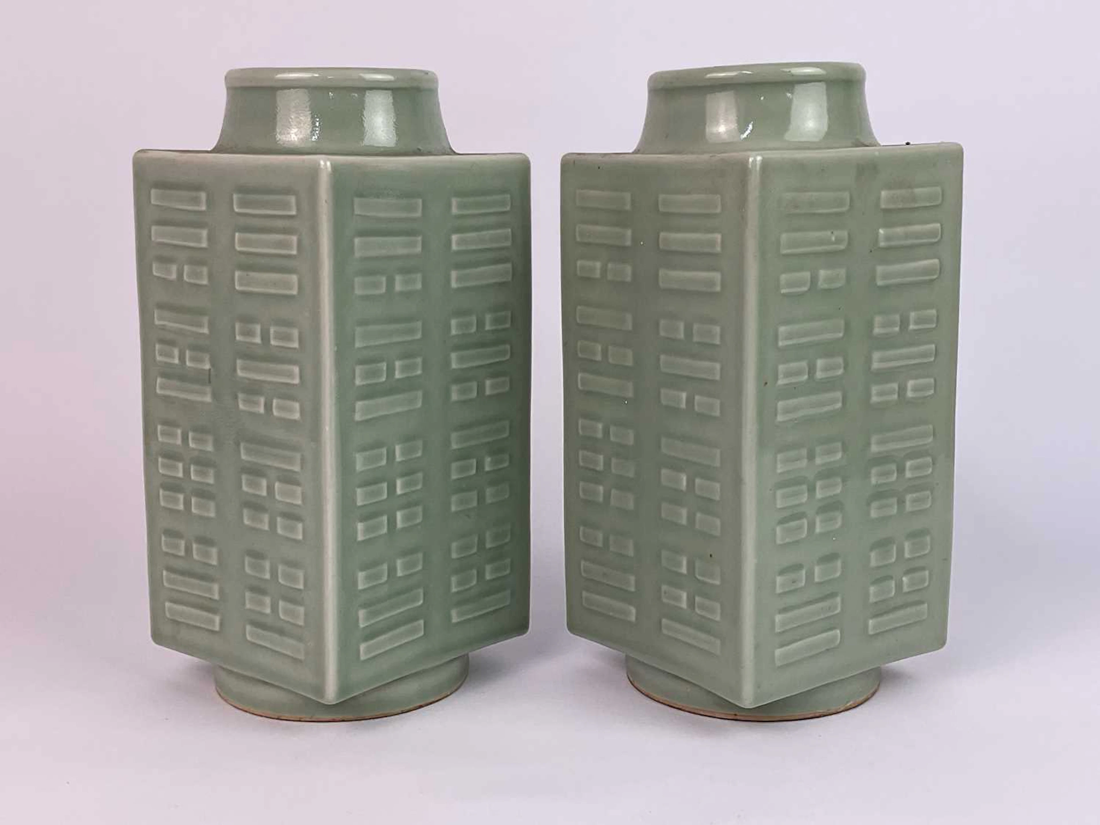 A pair of Chinese celadon glazed cong vases with molded...
