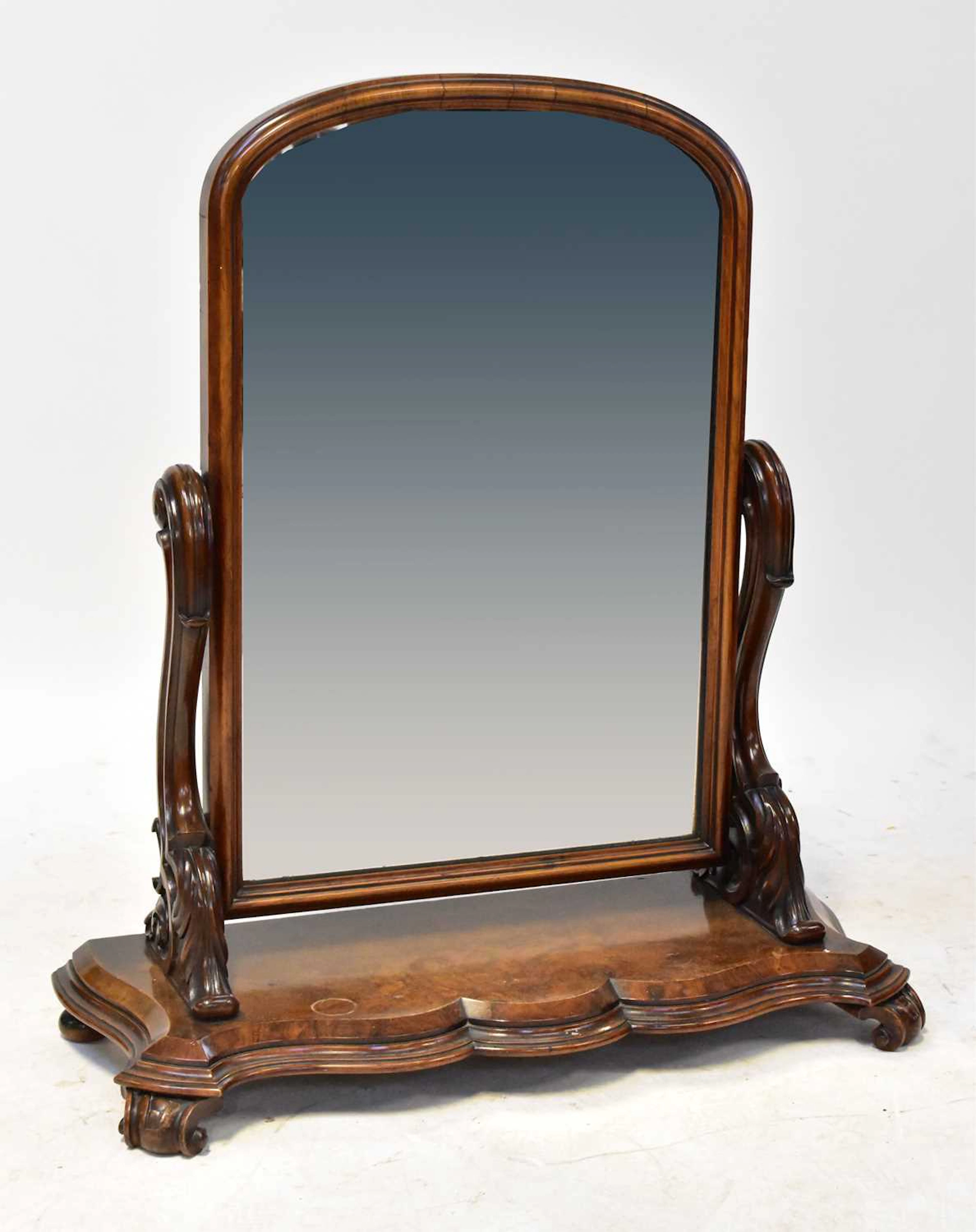 A Victorian walnut toilet/dressing table mirror