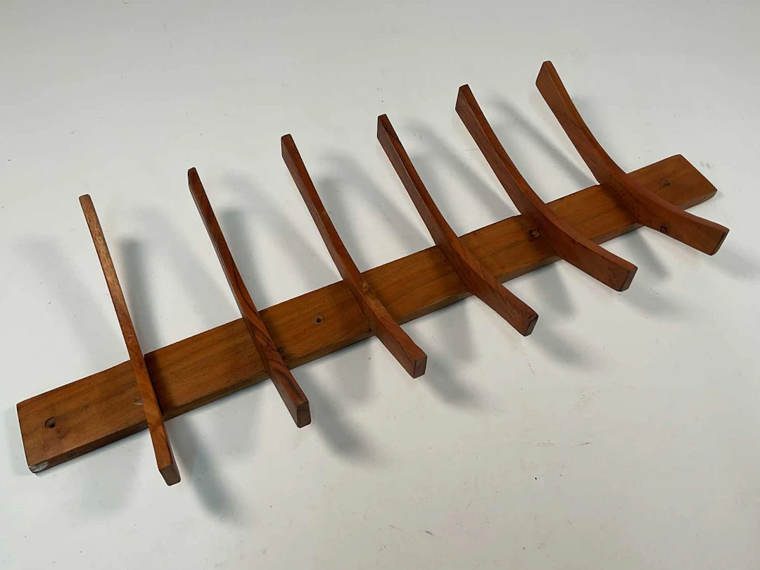 A mid 20th century teak wall mounted coat rack