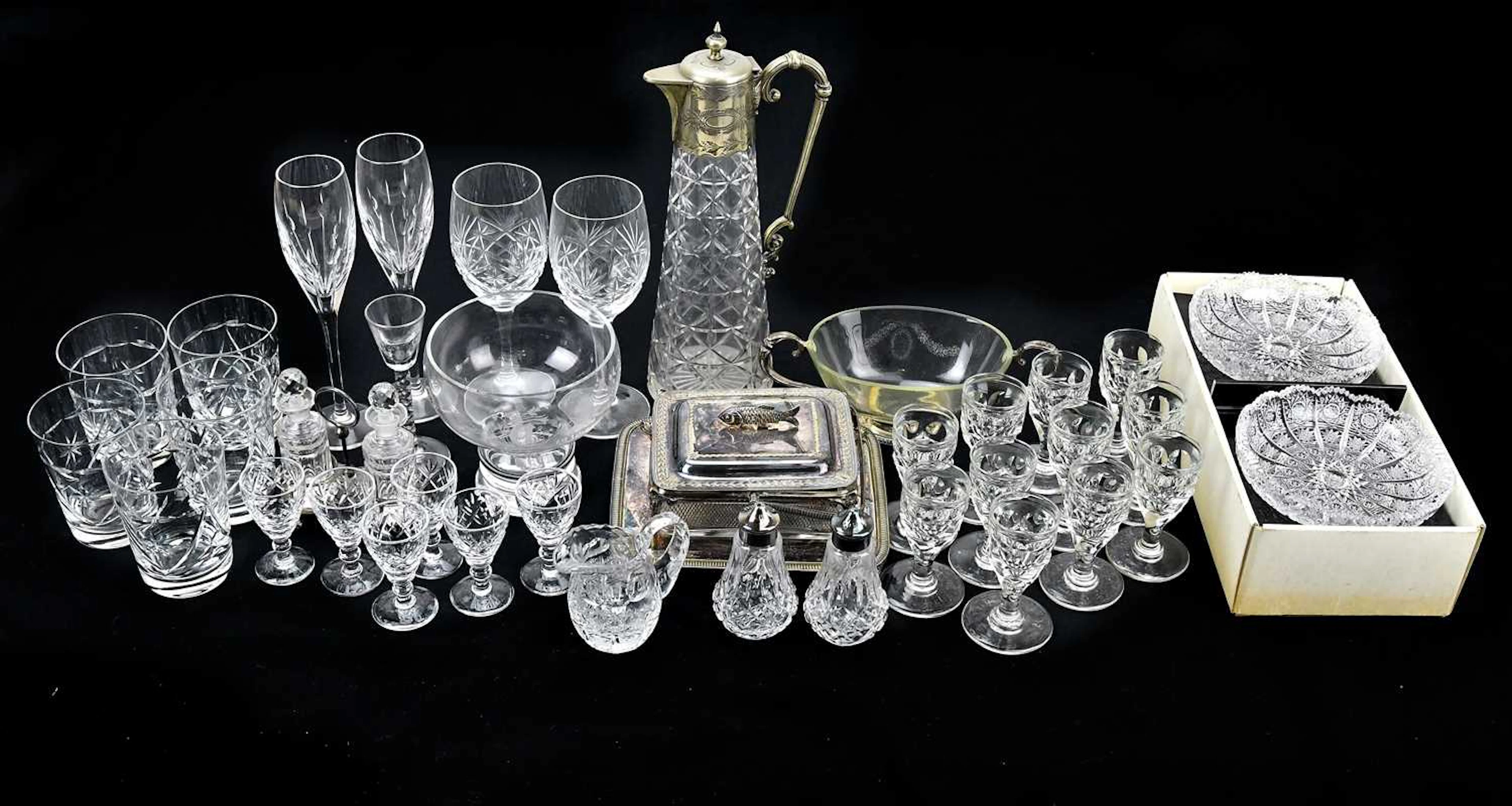 A collection of cut glass including champagne flutes