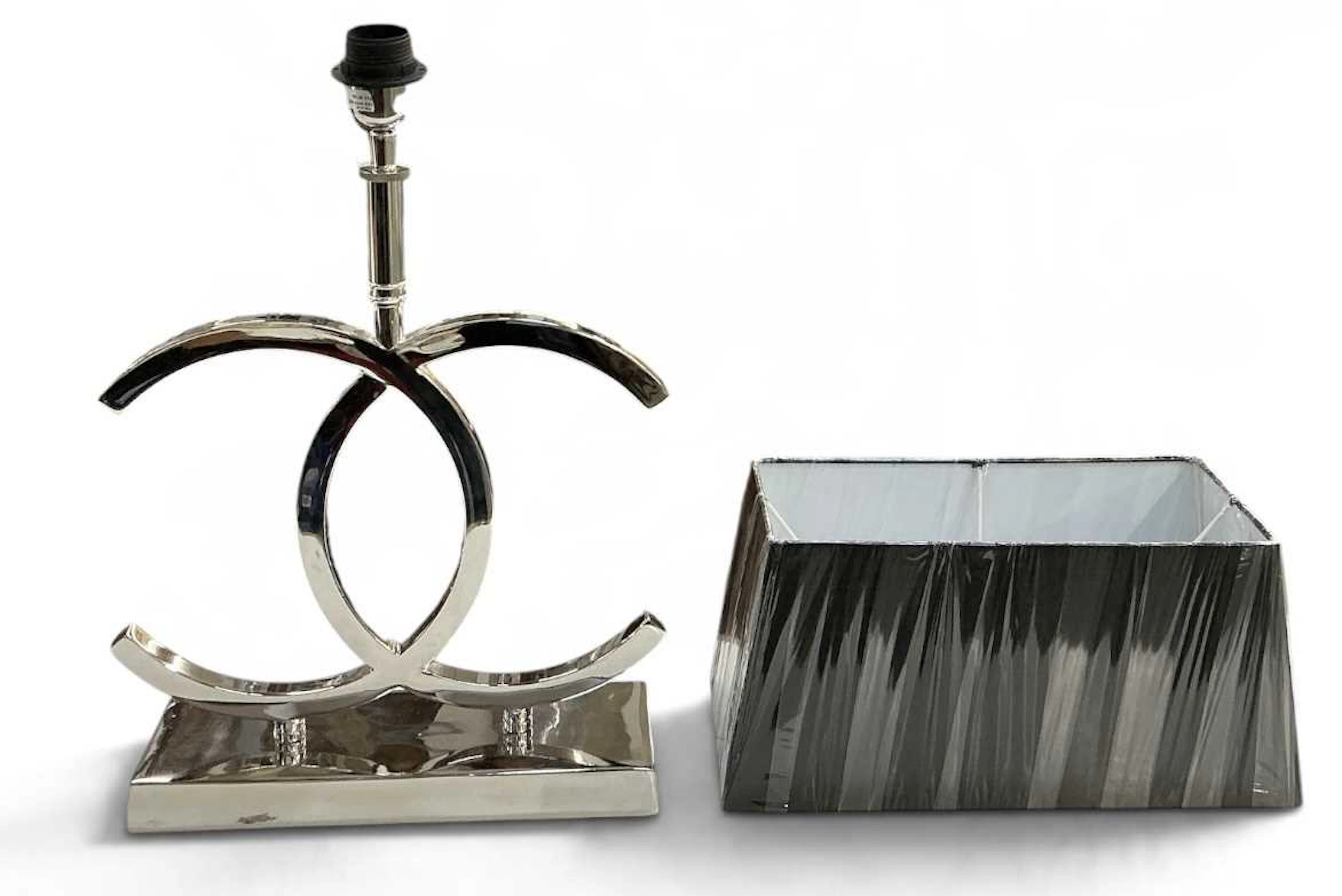 IN THE MANNER OF CHANEL; a modern contemporary chrome table lamp