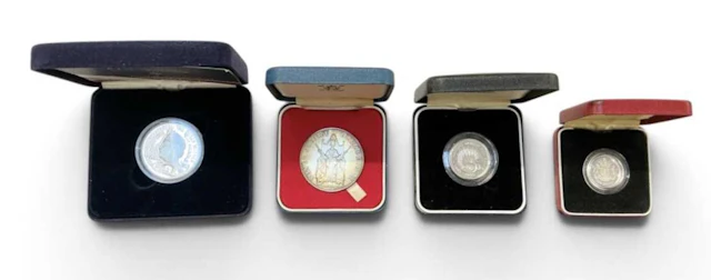 Four assorted encapsulated silver proof coins