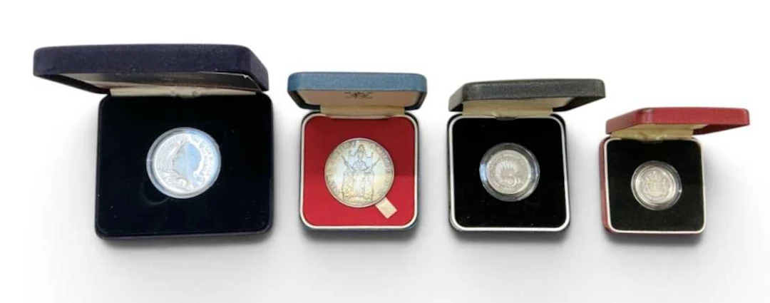 Four assorted encapsulated silver proof coins