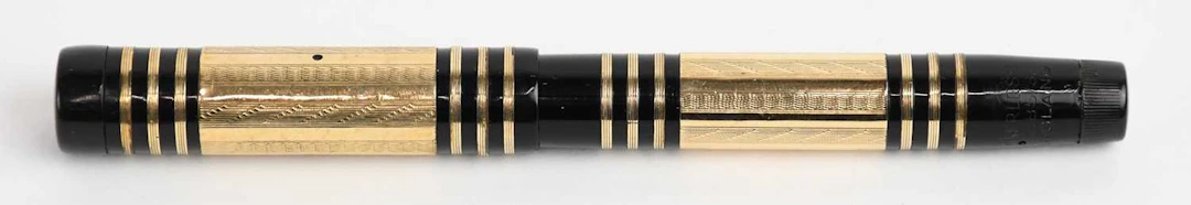 SWAN/MABIE TODD; a 1930s black bakelite plastic gold...