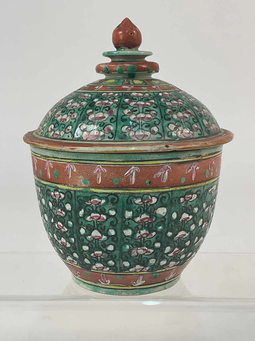 A Chinese Benjarong porcelain covered jar with a green...