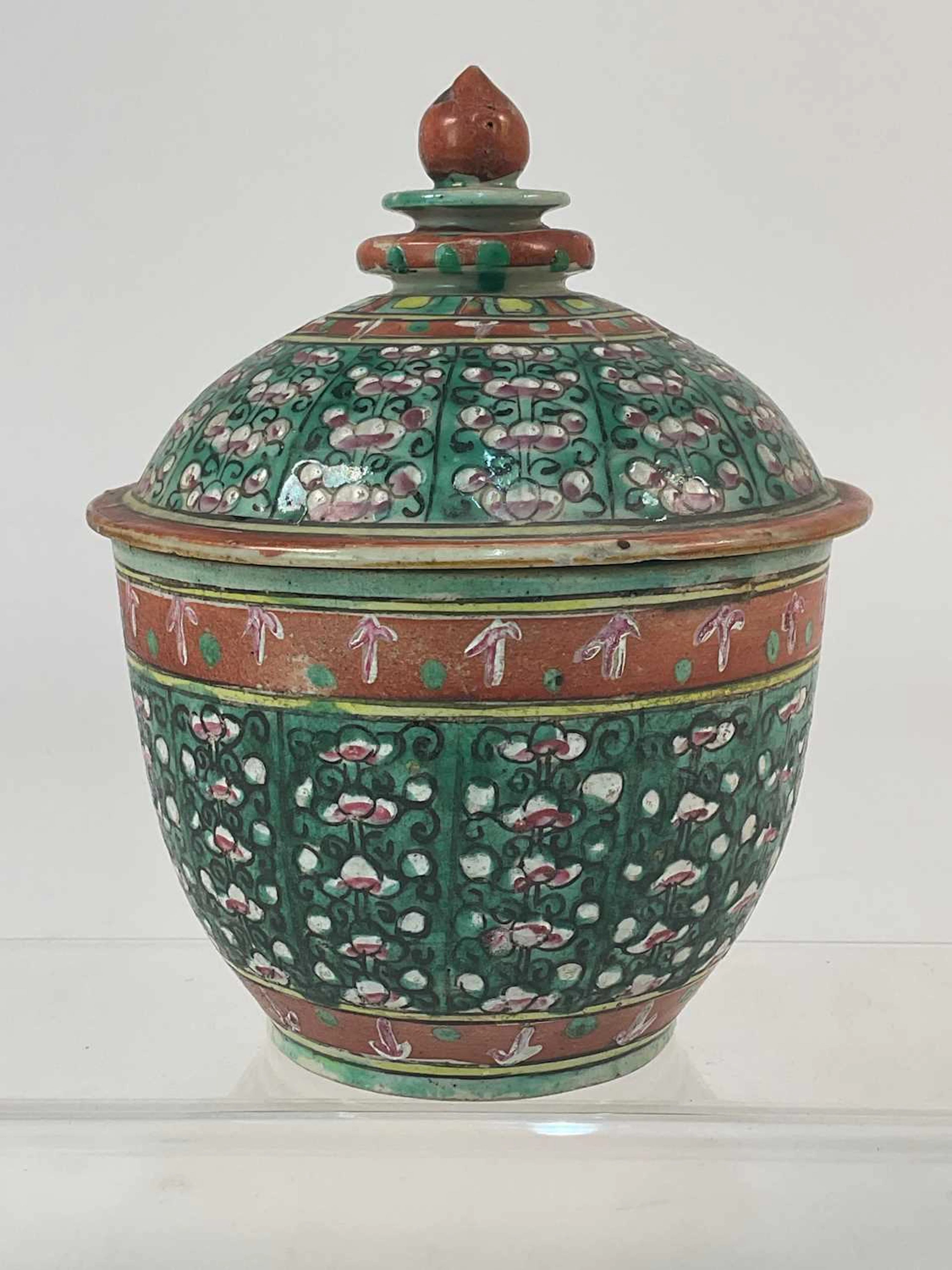 A Chinese Benjarong porcelain covered jar with a green...