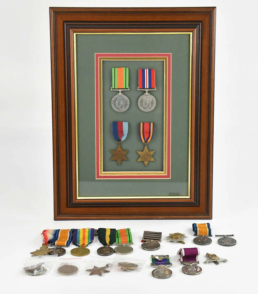A framed montage containing four WWII medals comprising the 1939-45 Star